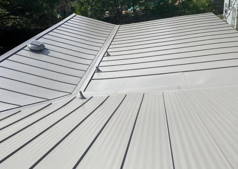 Solar attic fan installed on a metal roof for Roof Ventilation in Whispering Pines